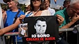 A woman holds a photo of Charlie Kirk that reads: "I am Charlie Kirk", during the League party's annual gathering in Pontida, north of Italy, Sunday, Sept. 21, 2025.