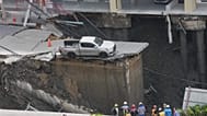 Damage is seen after a road collapse near Vajira Hospital in Bangkok.