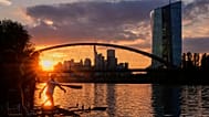 The sun sets behind the European Central Bank, right, in Frankfurt, Germany. 10 Sept. 2025.