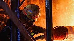 Feuerwehrleute löschen das Feuer nach einem russischen Drohnenangriff in Charkiw.