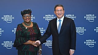 FILE. Chinese Premier Li Qiang shakes hands with Director-General of the WTO Ngozi Okonjo-Iweala, in Tianjin, a World Economic Forum meeting. 26 June 2023.