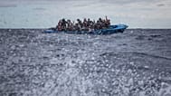 An overcrowded wooden boat in distress in the Mediterranean Sea