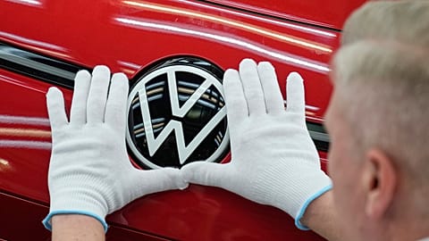 An employee of the German car manufacturer Volkswagen checks an ID.3 electric car at the transparent factory in Dresden, Germany. 14 May 2025.