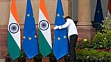 A worker adjusts a EU flag placed for the meeting of Indian Prime Minister Narendra Modi and EU Commission President Ursula von der Leyen in New Delhi, Feb. 28, 2025.