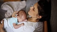 A woman holds her baby.