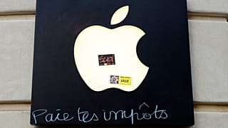 Graffiti written on an Apple sign reading "Pay your taxes", in front of an Apple store during a demonstration in 2019, in Lille, France.