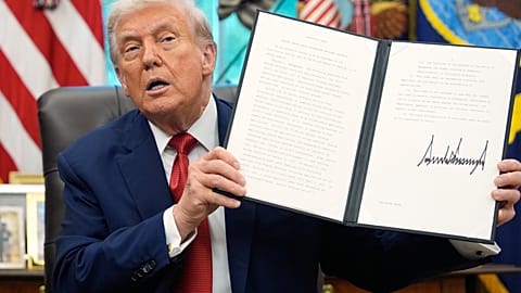 President Donald Trump holds a signed executive order regarding TikTok in the Oval Office at the White House, Thursday, Sept. 25, 2025, in Washington. 