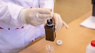 A scientist works with an extract.