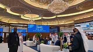 Delegates for the Global Cybersecurity Forum meet in a corridor at the Ritz Carlton in Riyadh, Saudi Arabia