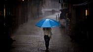 A woman walks in heavy rain in Barcelona, 11/ 09/ 2025.