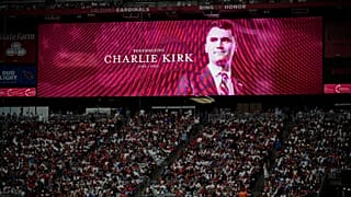 A photo of the conservative activist Charlie Kirk is seen on a large screen during a memorial in Glendale, 21 September, 2025