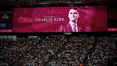 A photo of the conservative activist Charlie Kirk is seen on a large screen during a memorial in Glendale, 21 September, 2025