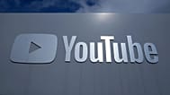 FILE - A YouTube sign is shown near the company's headquarters in San Bruno, Calif., Wednesday, March 12, 2025.