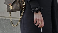 FILE: A woman holds a cigarette during a break in Paris, 28 May 2025