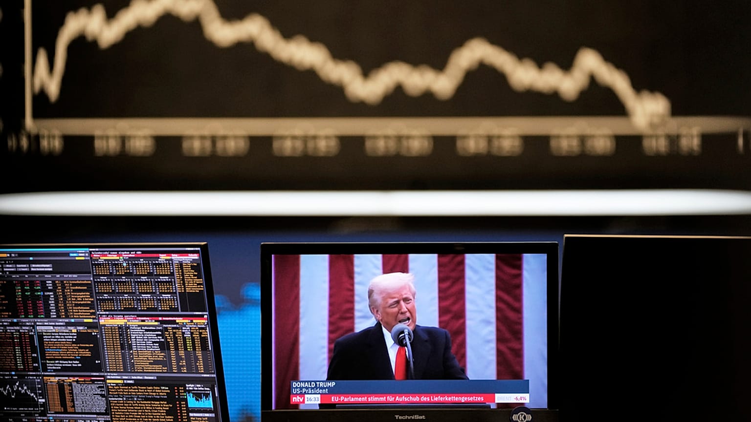 US President Donald Trump appears on a television screen at the stock market in Frankfurt, Germany, Thursday, 3 April 2025.