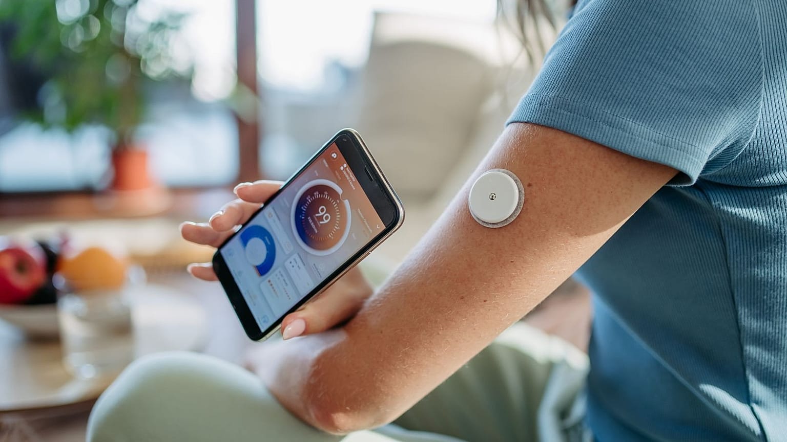 A woman uses a continuous glucose monitor.