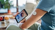 A woman uses a continuous glucose monitor.