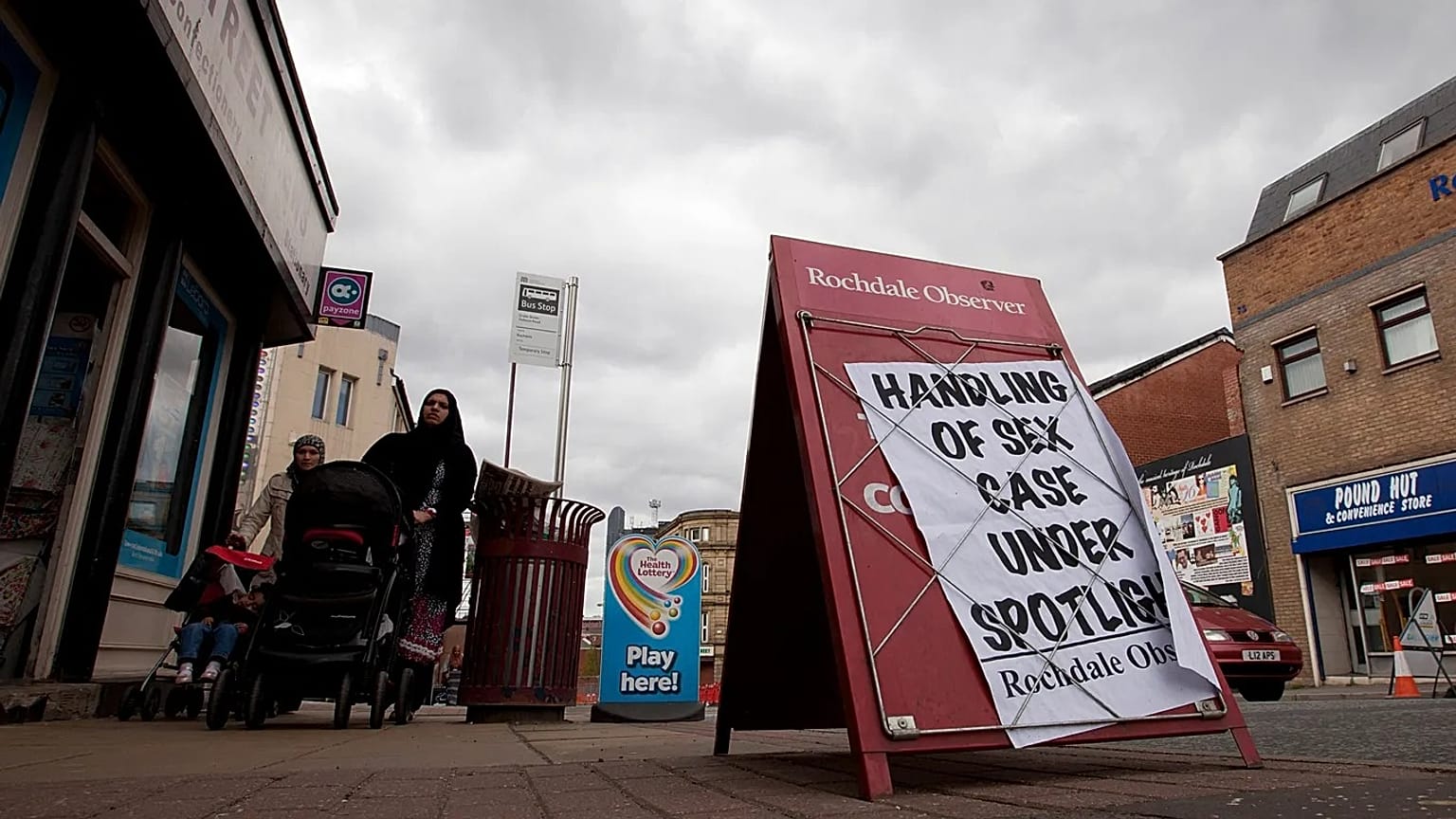 FILE: A newspaper advertising board in Rochdale, England during the emergence of one of a series of "grooming gang" scandals, May 16, 2012