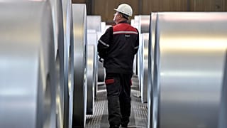 A worker controls steel coils at the thyssenkrupp steel factory in Duisburg, Germany, 27 April 2018.