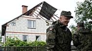 Αξιωματικοί της εδαφικής άμυνας στέκονται δίπλα σε ένα κατεστραμμένο σπίτι μετά την παραβίαση του πολωνικού εναέριου χώρου από ρωσικά μη επανδρωμένα αεροσκάφη κατά τη διάρκεια επίθεσης στην Ουκρανία