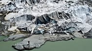  Matthias Huss, of the Federal Institute of Technology in Zurich and glacier monitoring group GLAMOS, stands at the Rhone Glacier that is partially covered with sheets.