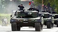 Polish soldiers parade through the streets of Swietoszow, in southwestern Poland, in Leopard tanks on 16 Sept., 2002