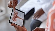 Patient Holding Tablet with Female Reproductive System
