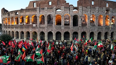 Pro-Palestinian demonstrators gather in front of the Colosseum in Rome, Thursday, Oct. 2, 2025.