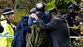 Members of the Jewish community comfort each other near to the Heaton Park Hebrew Congregation synagogue in Manchester, 2 October, 2025