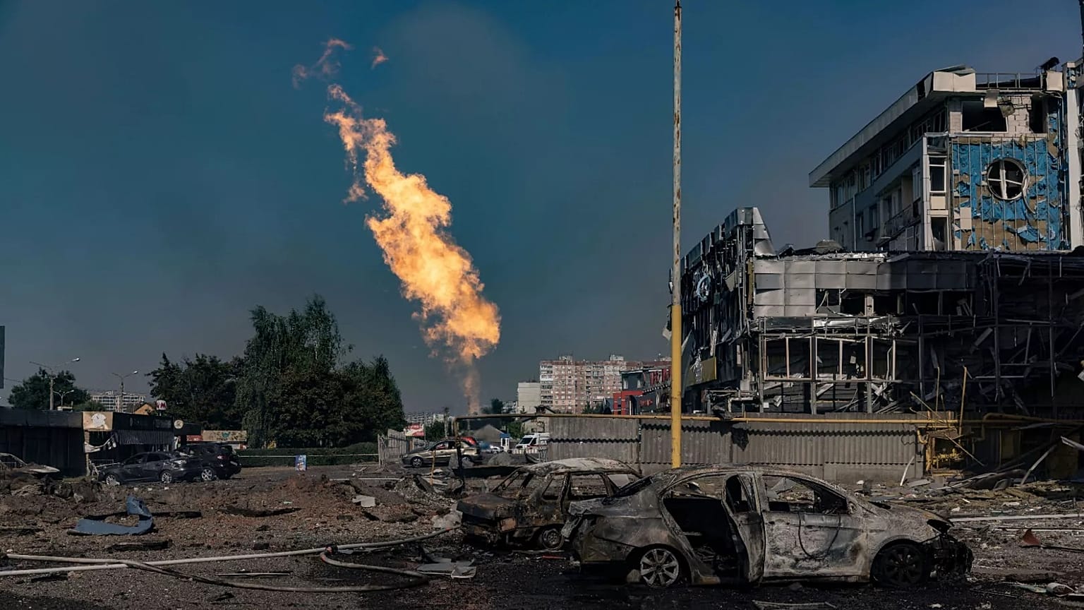 Gas burns in front of a business centre damaged by a Russian attack in Kharkiv, 1 September, 2024