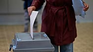 A woman casts her ballot for a general election at a poling station in Brno, 3 October, 2025