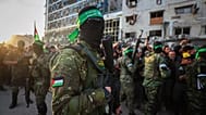 Fighters from Hamas control the crowd while the Red Cross collects Israeli hostages in Gaza City, 19 January, 2025