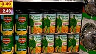 Cans of corn are shown on display in the produce section of the Table Mesa King Soopers store in Boulder, 8 February, 2022