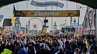 Visitors walk to the re-opening of the Oktoberfest that was closed since the morning after a bomb threatening in Munich, 1 October, 2025