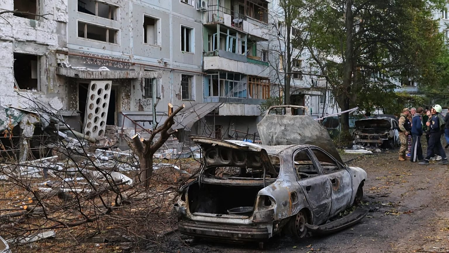 Burned cars and damaged residential building are seen after a Russian strike in Zaporizhzhia, Ukraine, Sunday, Oct. 5, 2025.
