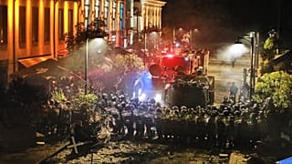 Police block a street to prevent demonstrators from advancing during an opposition rally in the city center of Tbilisi, Georgia, on Saturday, Oct. 4, 2025