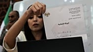 A Syrian election official shows a ballot paper during the counting of ballots, shortly after polling stations closed at Latakia's Governor building, Sunday, Oct. 5, 2025