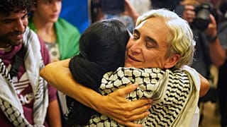 La exalcaldesa de Barcelona Ada Colau saluda a una conocida a su llegada a España