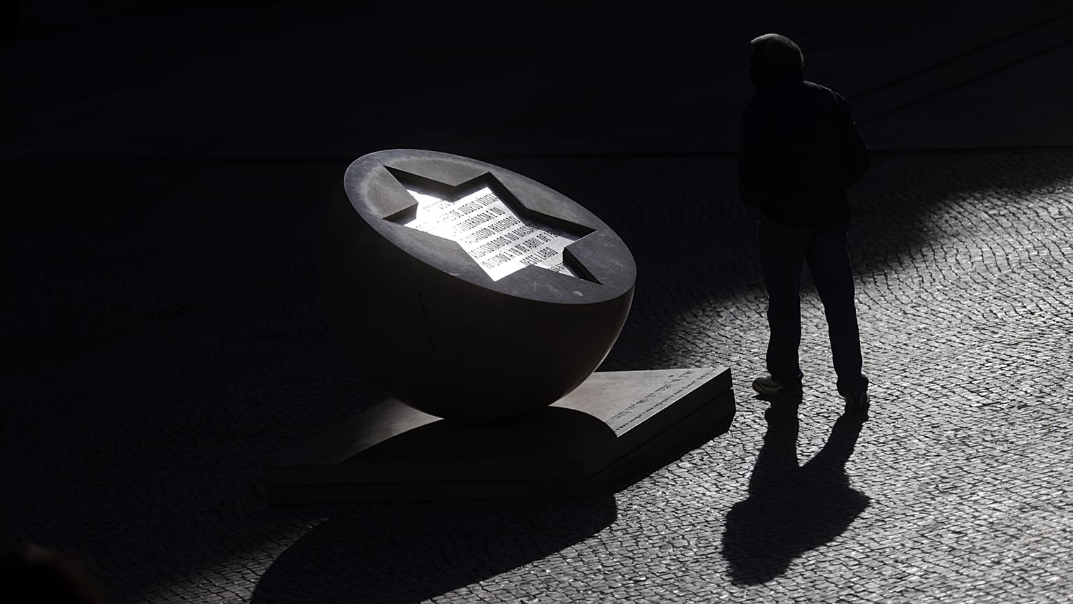 Una mujer pasa junto a un monumento a los judíos que se cree fueron asesinados en este lugar durante un pogromo perpetrado por la población local en 1506, en Lisboa.