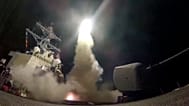 FILE - In this file image from video provided by the U.S. Navy, the guided-missile destroyer USS Porter launches a tomahawk missile in the Mediterranean Sea, Apr 7, 2017.