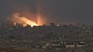 A fire erupts amid buildings destroyed during Israeli ground and air operations in northern Gaza, 6 October, 2025