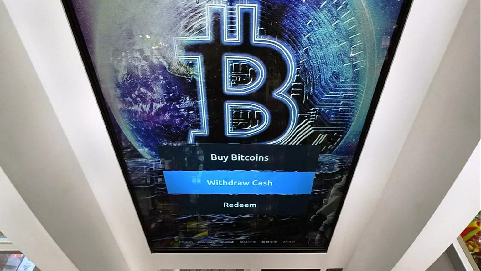 FILE - The Bitcoin logo appears on the display screen of a cryptocurrency ATM in Salem, N.H., 9 February 2021.