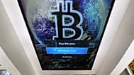 FILE - The Bitcoin logo appears on the display screen of a cryptocurrency ATM in Salem, N.H., 9 February 2021.