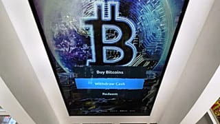 FILE - The Bitcoin logo appears on the display screen of a cryptocurrency ATM in Salem, N.H., 9 February 2021.