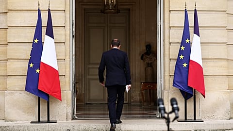 French outgoing Prime Minister Sebastien Lecornu, who resigned just a day after naming his government, walks back after delivering his statement at the Hotel Matignon in Paris