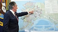 Interior Secretary Doug Burgum points to a map of Alaska as he speaks before President Donald Trump signs an executive order in the White House.