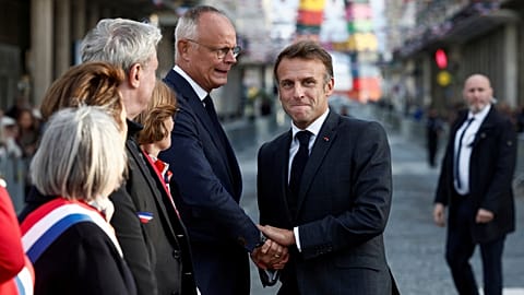 French President Emmanuel Macron shakes hands with Edouard Philippe as they attend a ceremony commemorating the 80th anniversary of the liberation of Le Havre, Sept. 12, 2024.