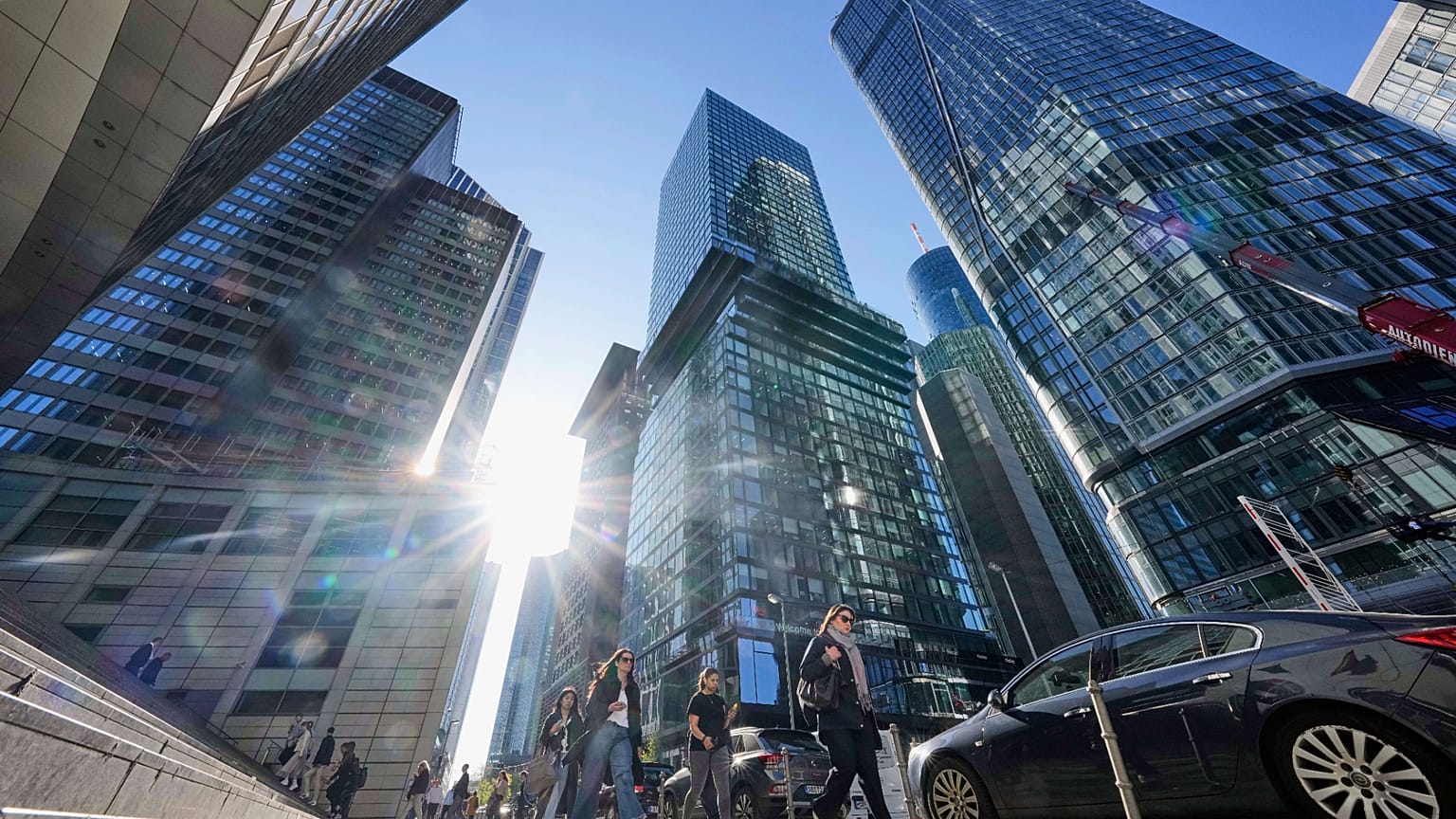 People walk in Germany's main financial district between bank headquarters in Frankfurt, Germany. 9 April 2025.