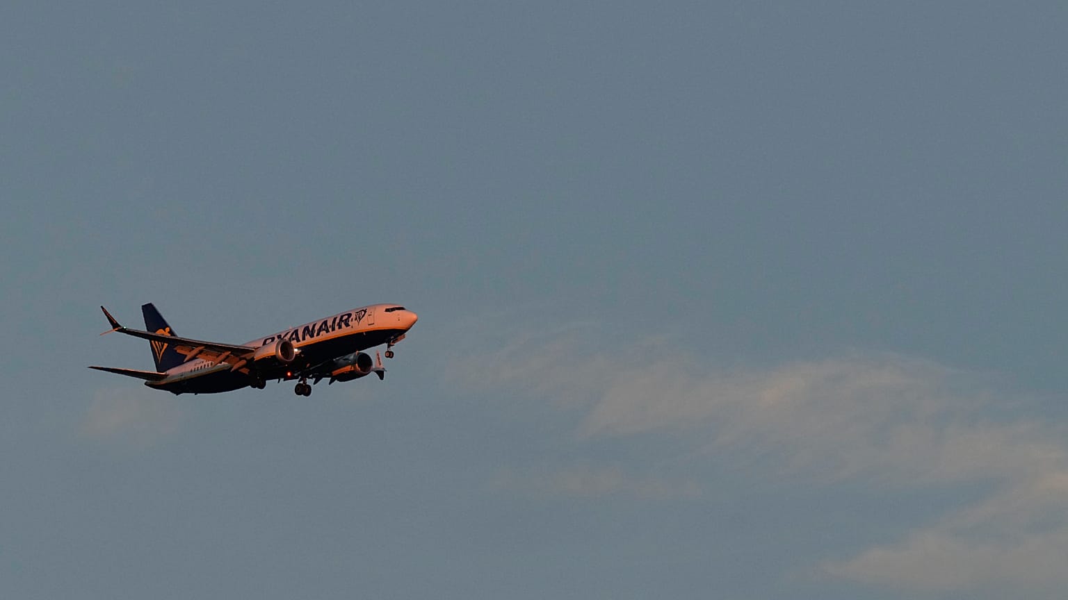 A Ryanair Boeing 737 MAX 8 approaches for landing in Lisbon at sunrise