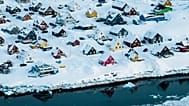 Houses covered by snow are seen on the coast of a sea inlet of Nuuk, 7 March, 2025